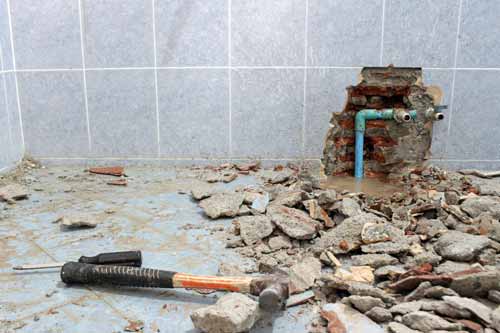 Sledge hammer around broken walling