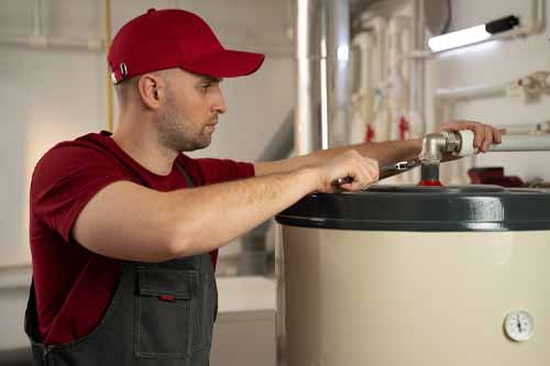 Tech fixing a water heater